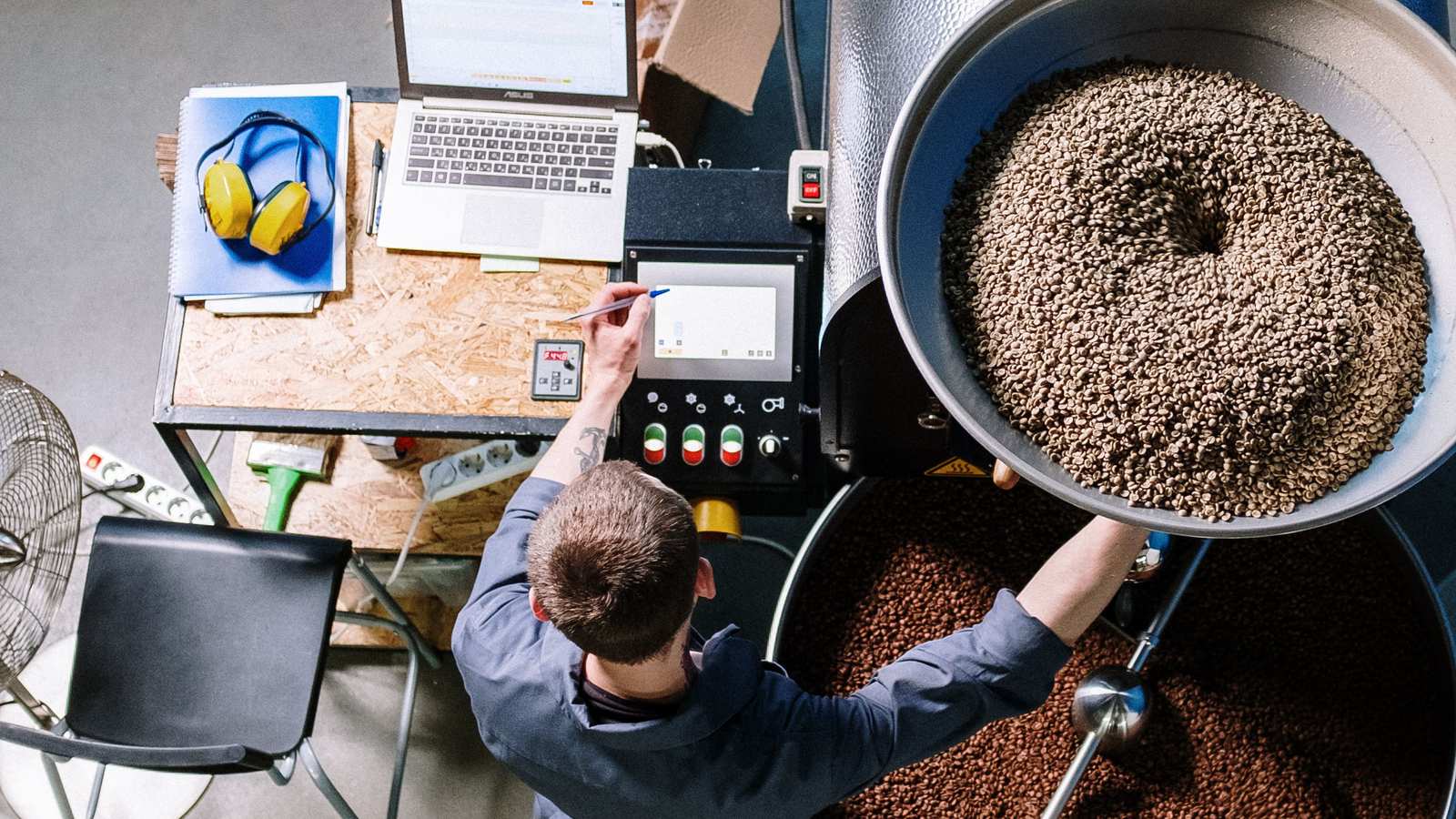A roaster pulling a fresh batch of coffee beans at Northbound Coffee Roasters